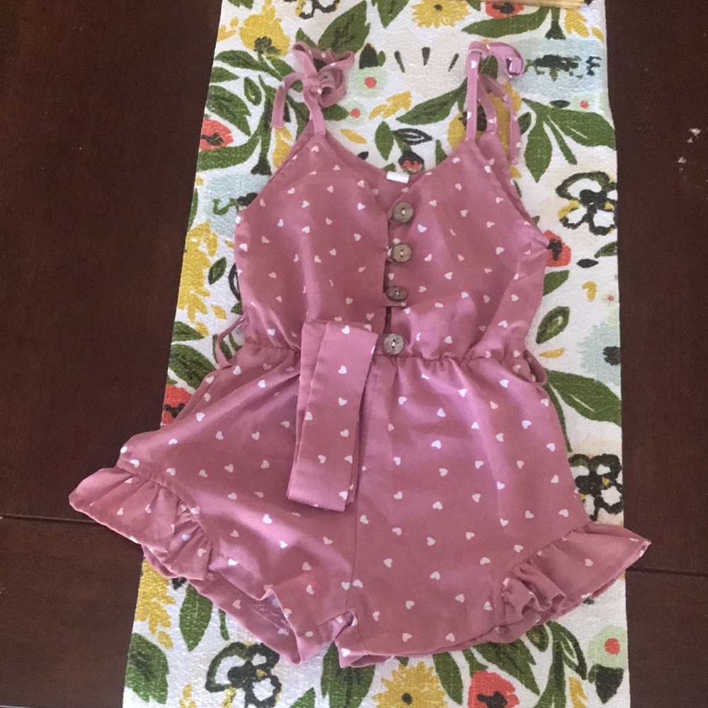Pink bodysuit with white hearts print
